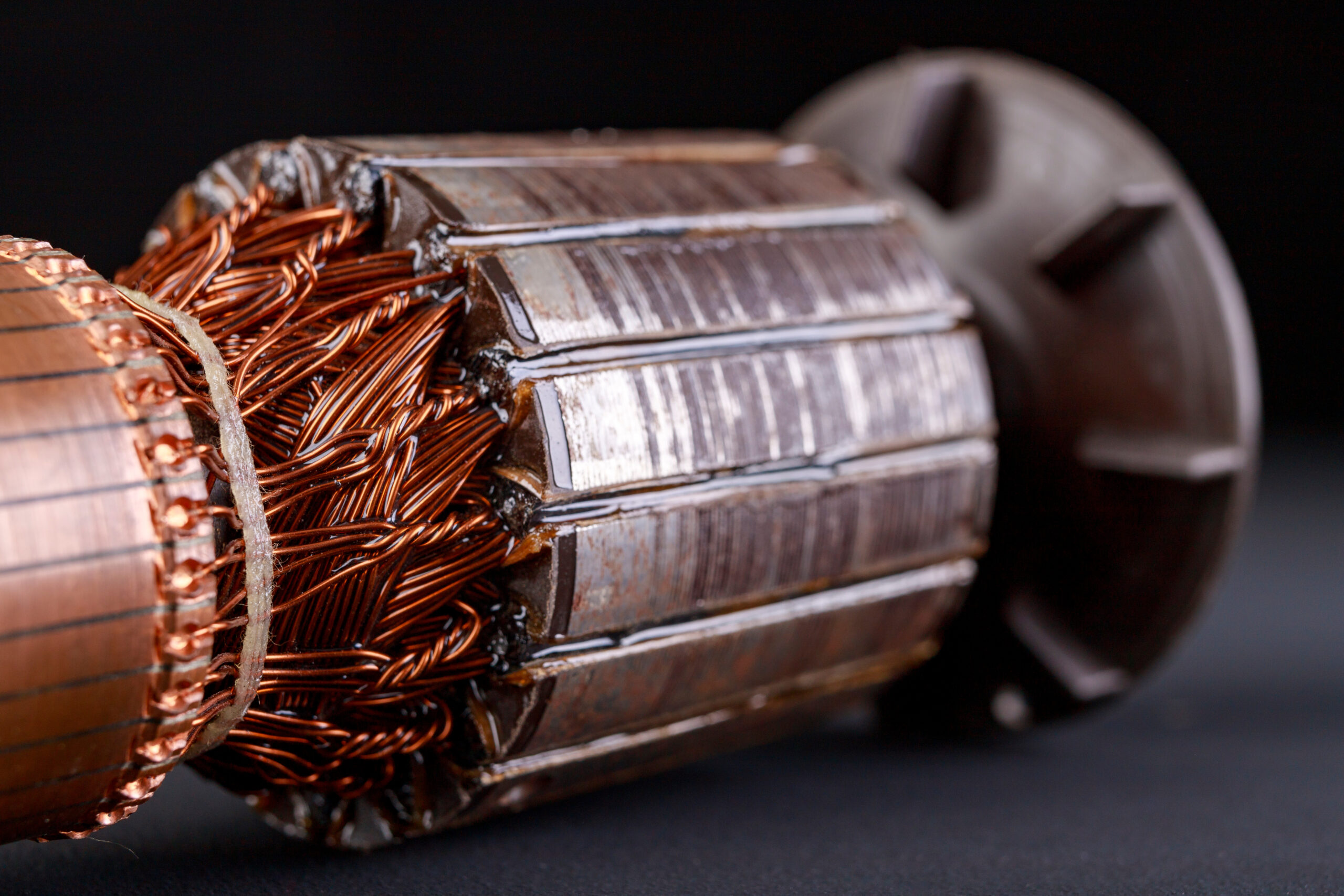 Electric motor rotor on a dark table. Accessories for overhaul and repair of engines. Black background.
